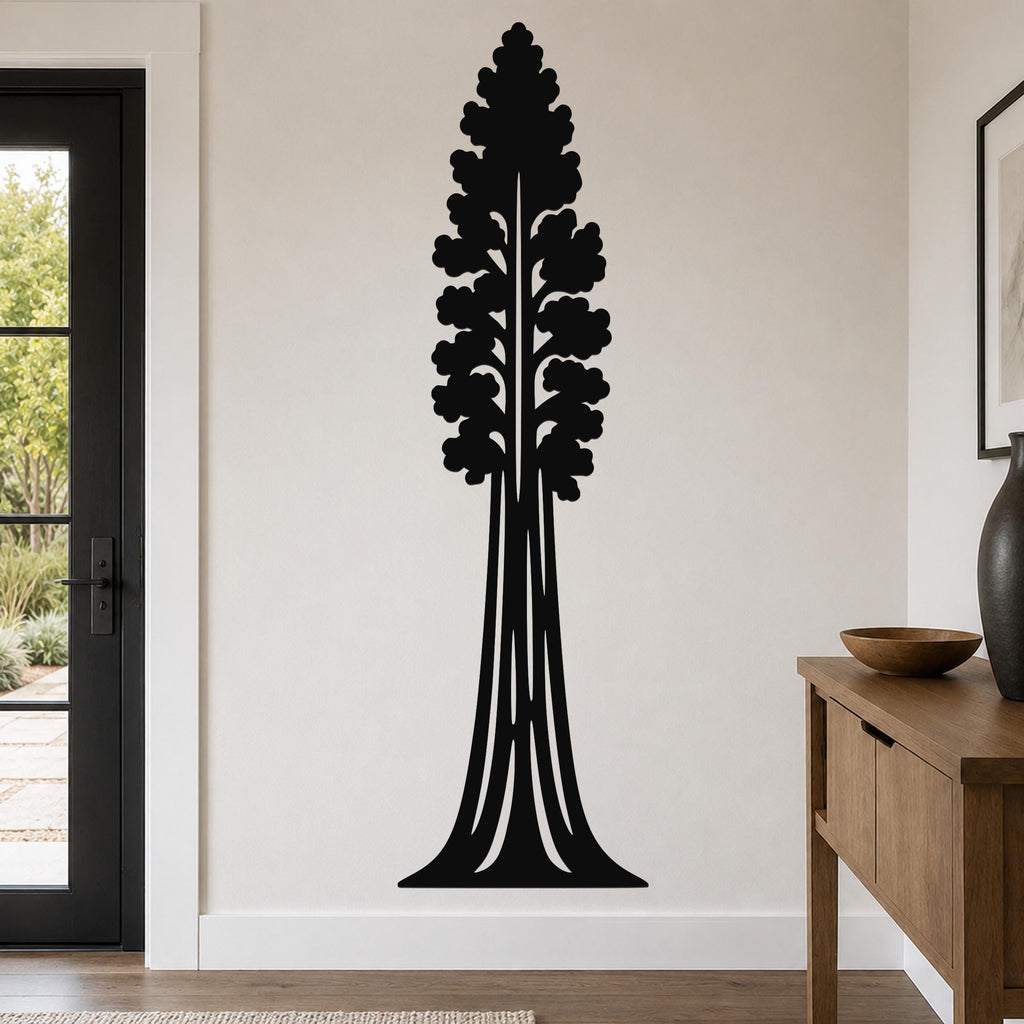 Black metal wall art in the silhouette of a sequoia tree with detailed branch cutouts, mounted on a living room wall above a wooden console table.