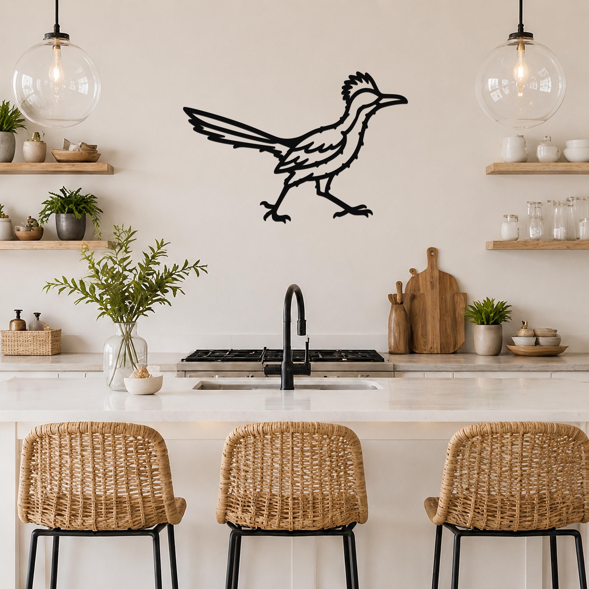 Black metal roadrunner wall art with motion-line cutouts, mounted on a kitchen wall above a counter.