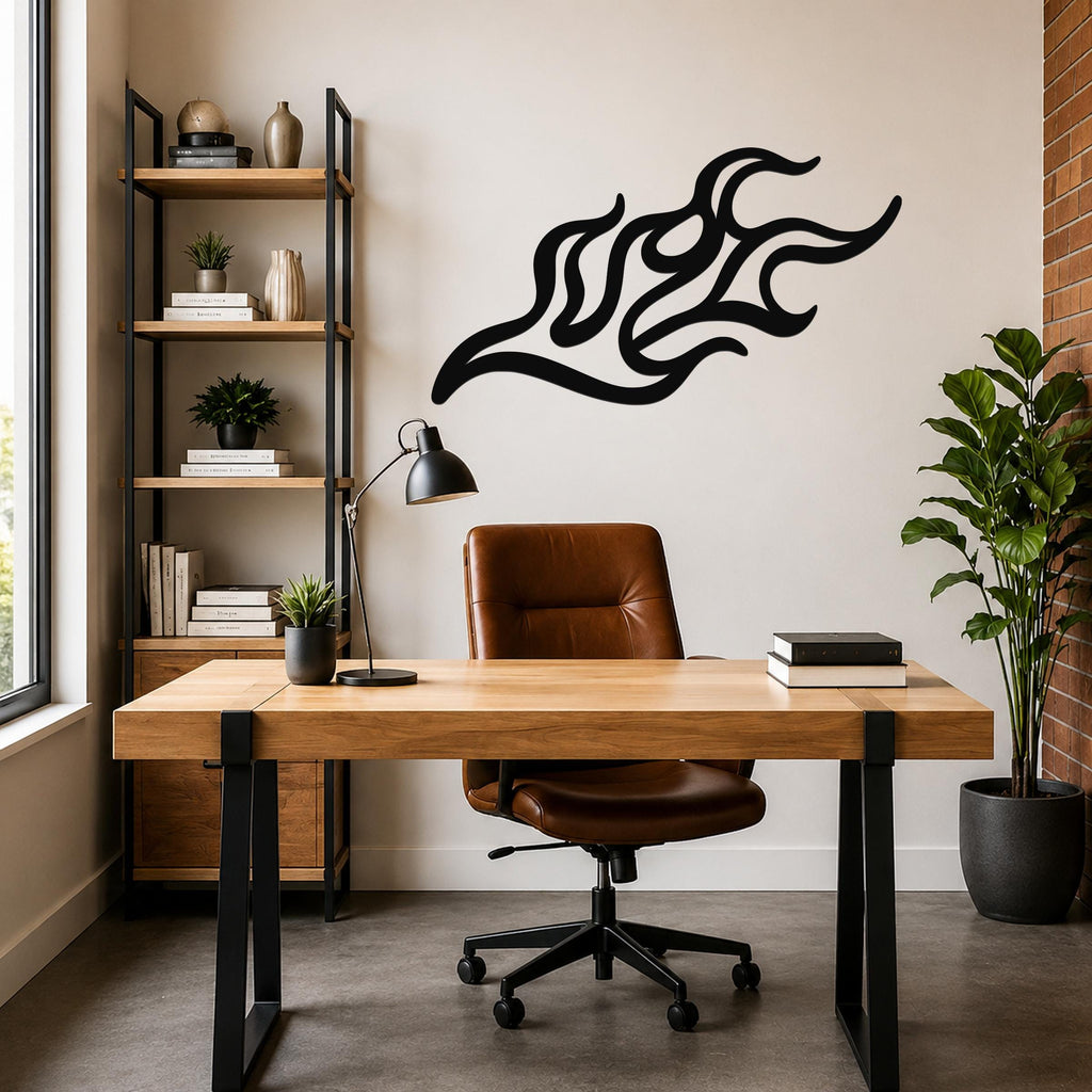 Black metal flame wall art with flowing, abstract cutout design, mounted on a wall above a wooden desk in a modern home office.