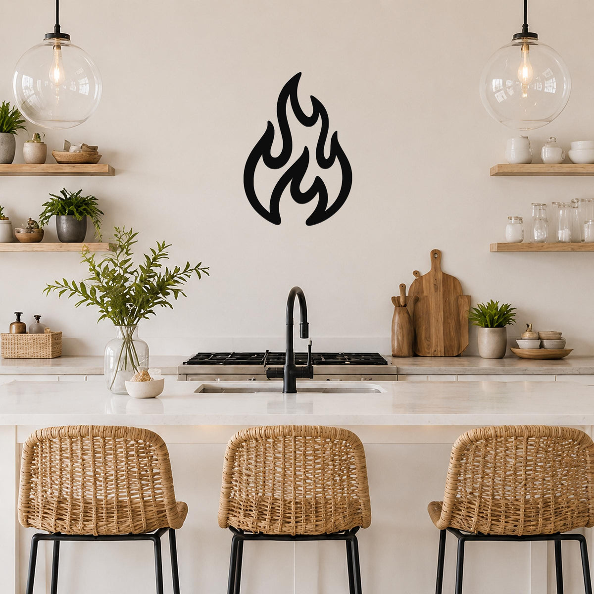 Black metal flame wall art with flowing cutout shapes, mounted on a kitchen wall above a counter.