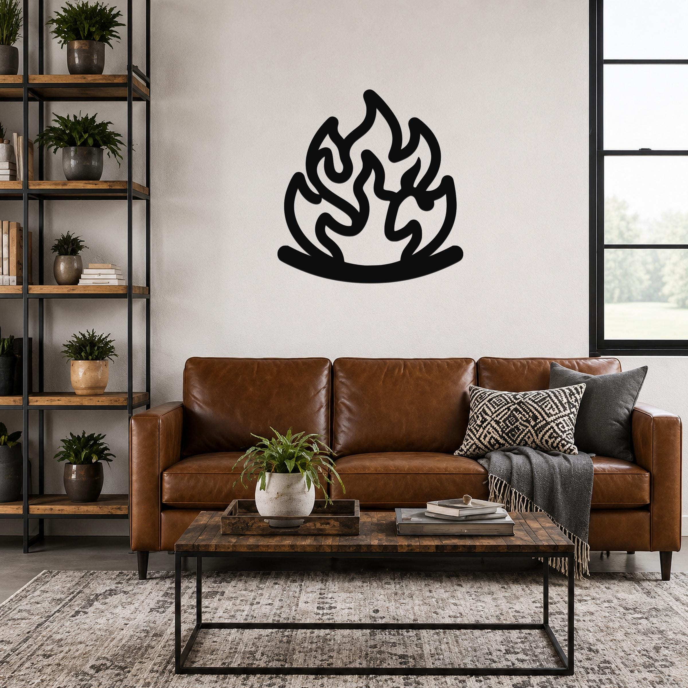 Black metal wall art in a flame silhouette with fluid motion lines, mounted above a brown leather sofa in a living room.