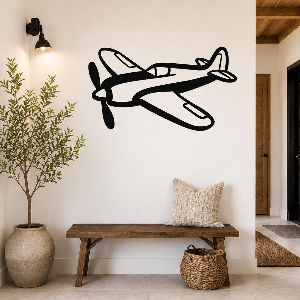 Black metal airplane wall art with a bold silhouette design, mounted on a white wall above a wooden bench in a hallway.