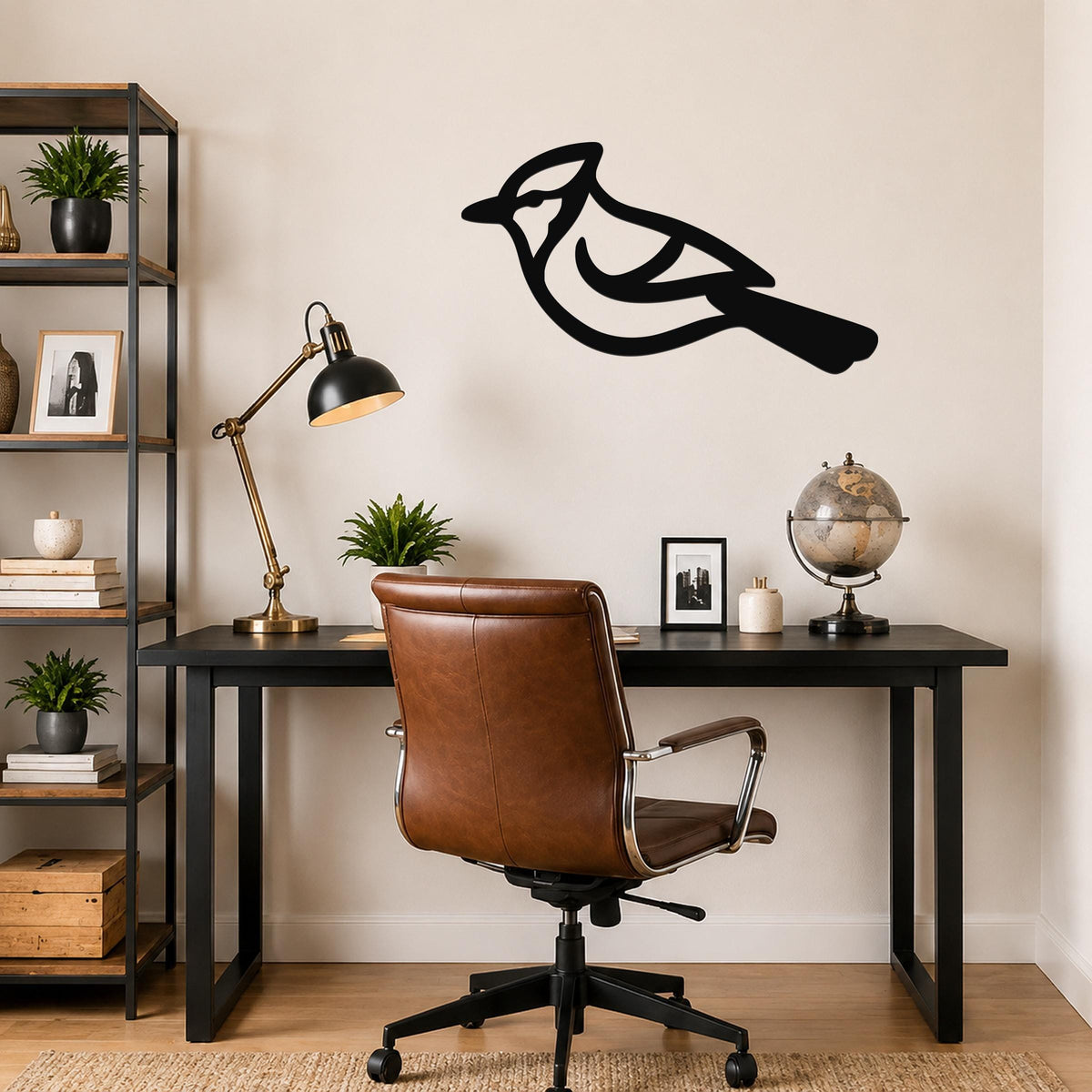 Black metal blue jay wall art silhouette mounted above a black desk in a home office.