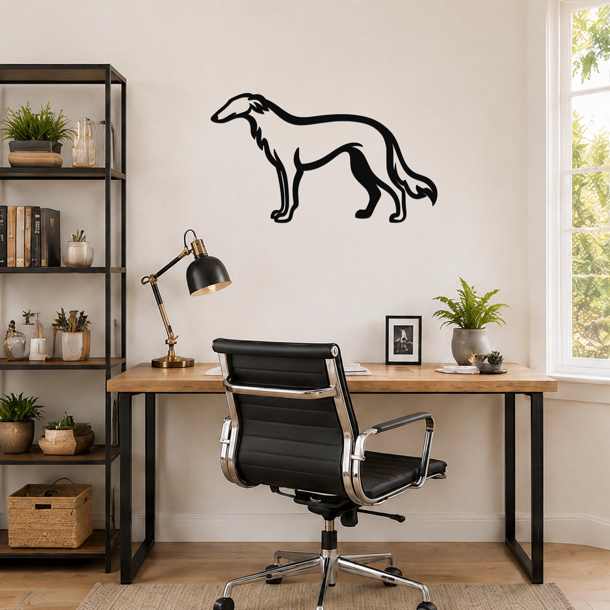 Black metal Borzoi dog wall art silhouette mounted on a light-colored wall above a wooden desk in a home office.