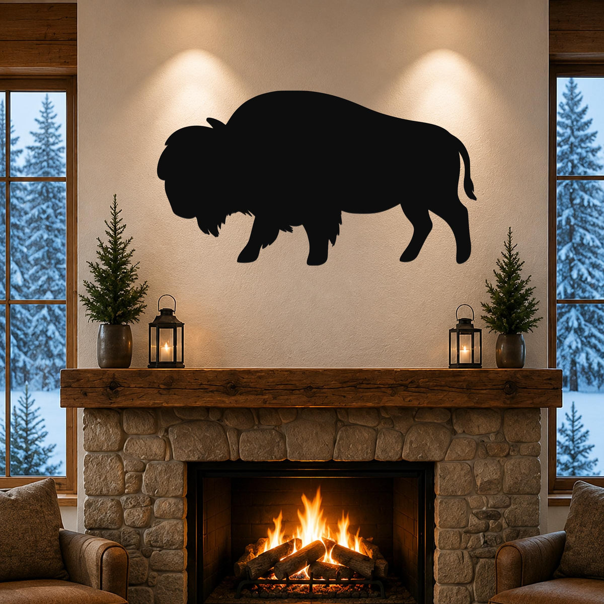 Black metal bison silhouette wall art mounted above a stone fireplace in a rustic living room with snow-covered trees visible through windows.