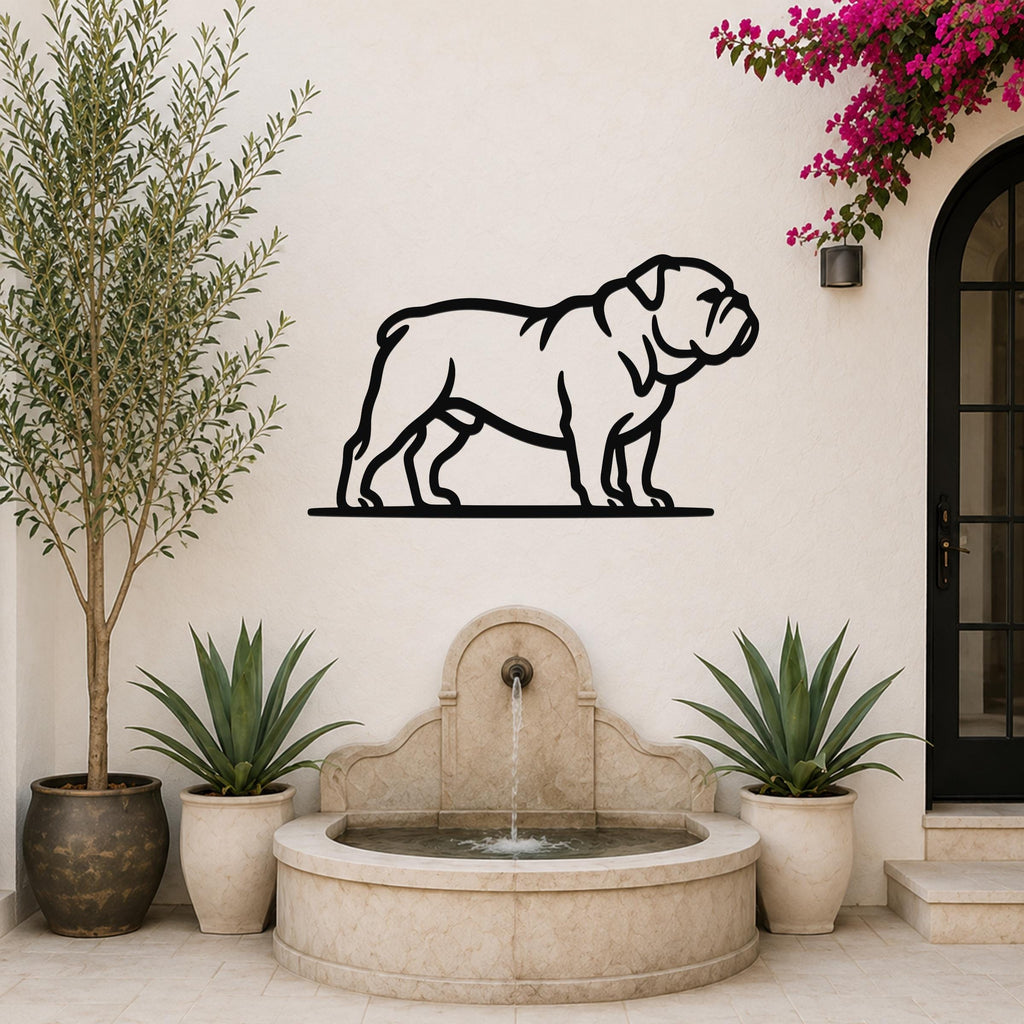 Black metal bulldog wall art silhouette mounted on a white outdoor wall above a stone fountain, flanked by potted plants and a blooming vine.