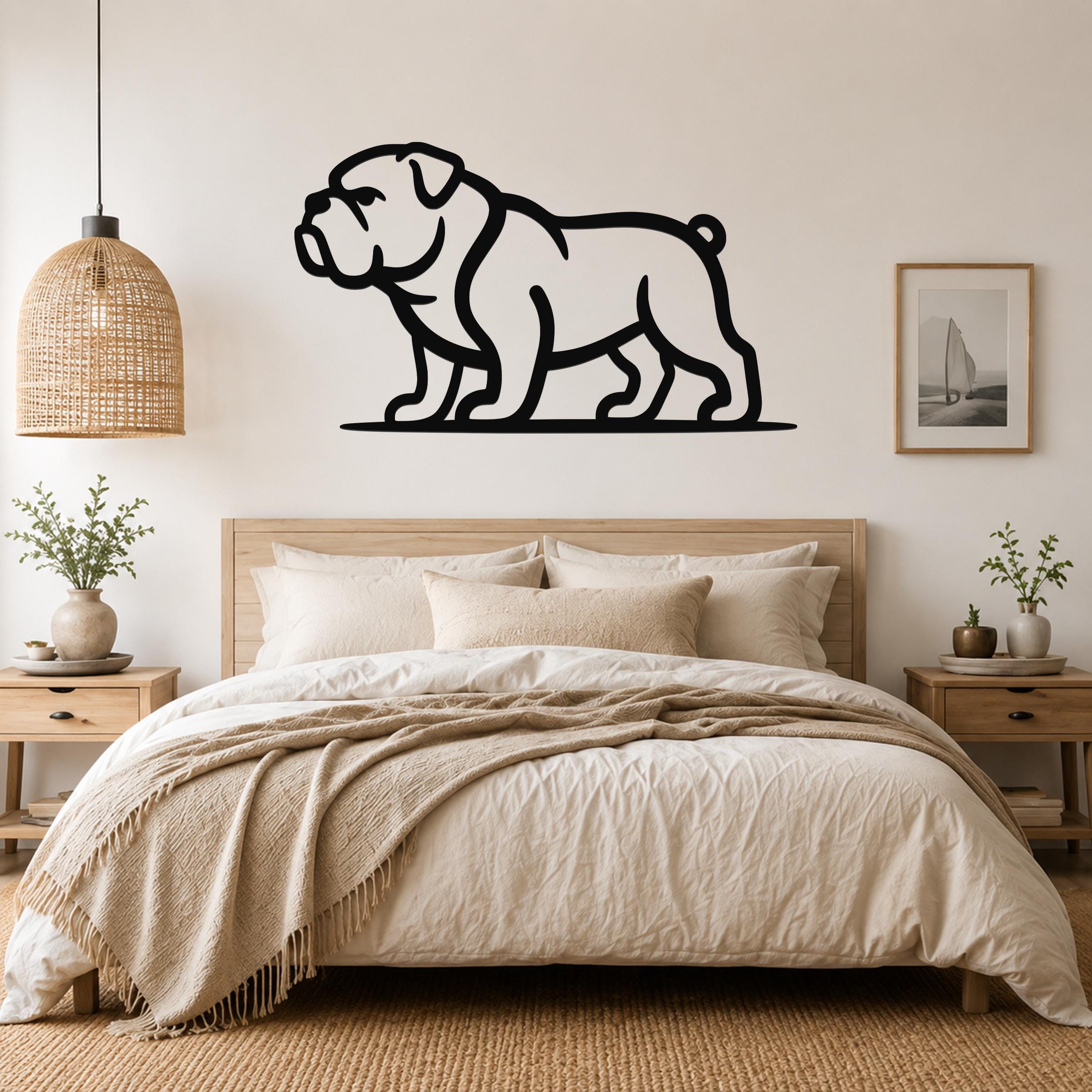 Black metal bulldog wall art silhouette mounted above a bed in a neutral bedroom.