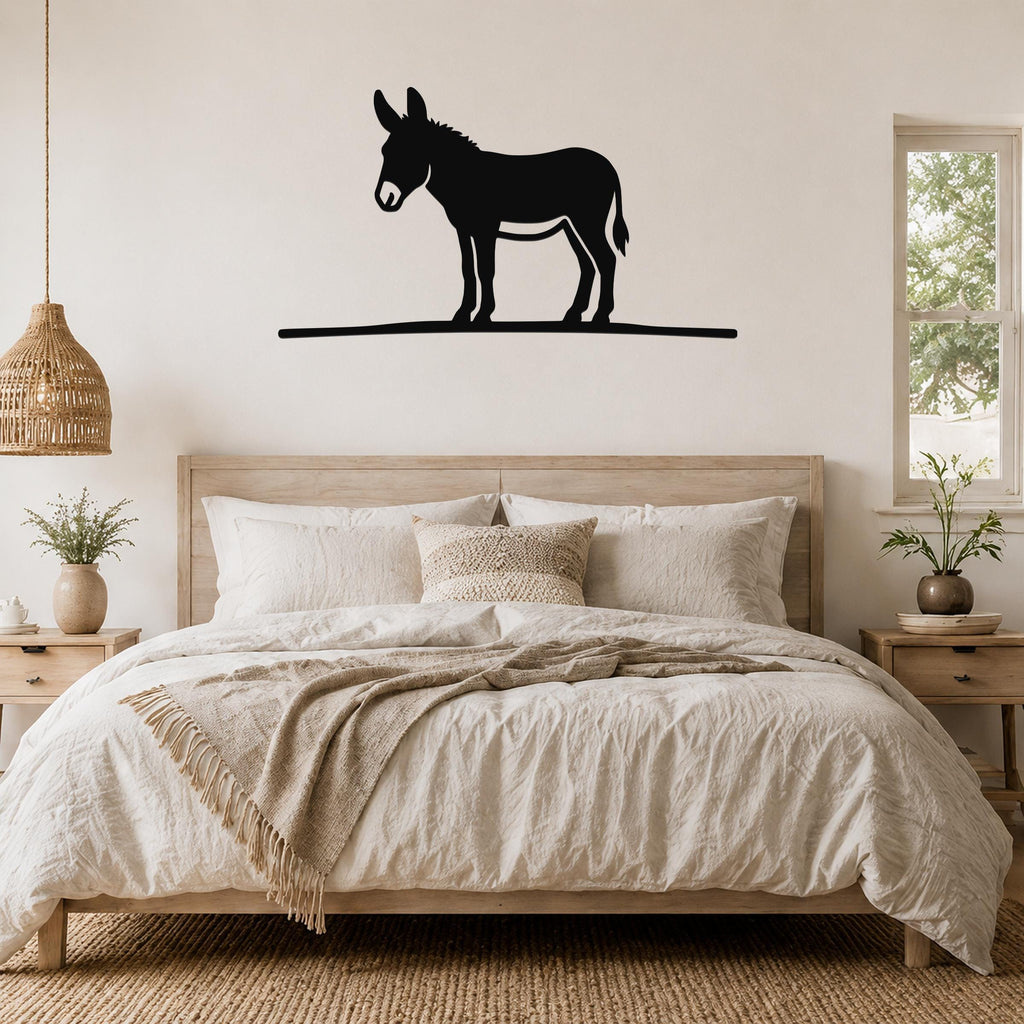 Black metal donkey wall art silhouette mounted above a bed in a neutral bedroom.