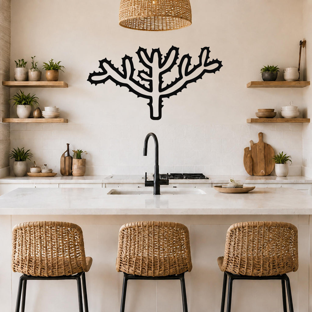 Black metal Cholla cactus wall art with spiky branch cutouts, mounted on a kitchen wall above a counter.