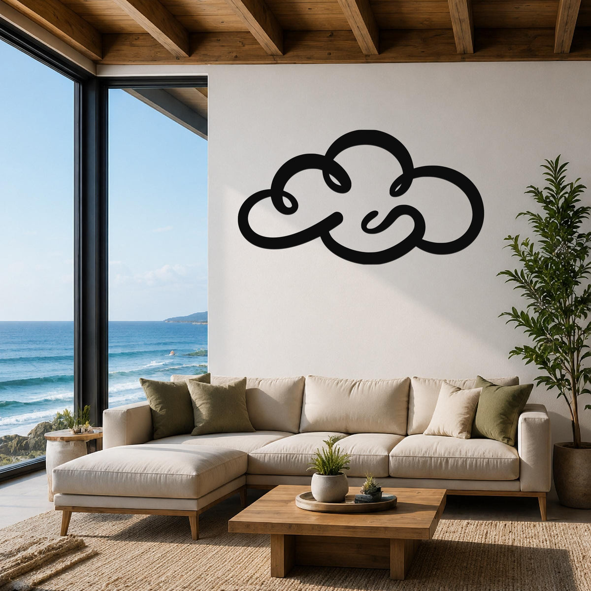 Black metal cloud wall art with flowing cutout lines, mounted above a beige sectional sofa in a living room with ocean views.