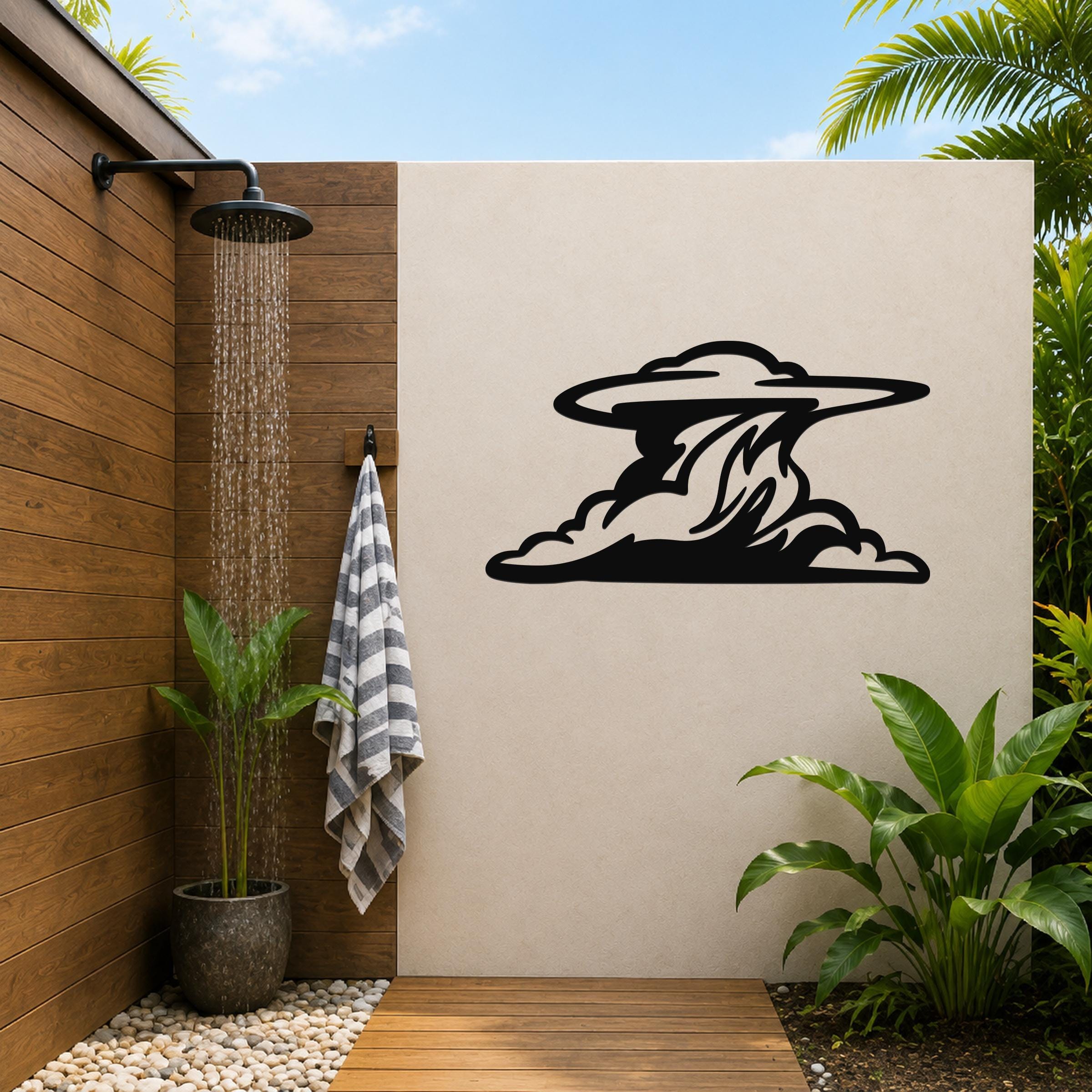 Black metal cloud silhouette wall art with flowing motion lines, mounted on a beige outdoor wall beside a wooden shower area.