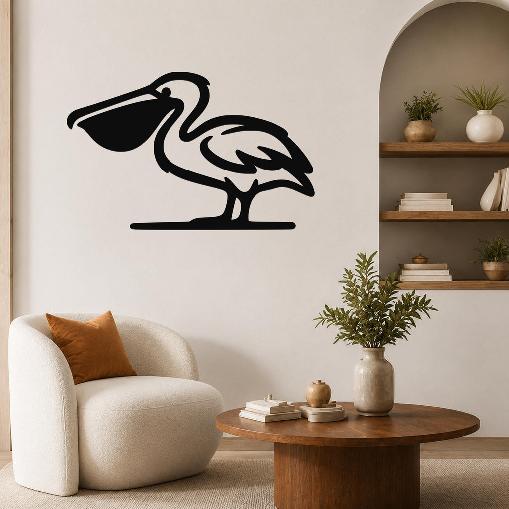 Black metal pelican wall art in silhouette style, mounted on a living room wall above a round wooden coffee table.