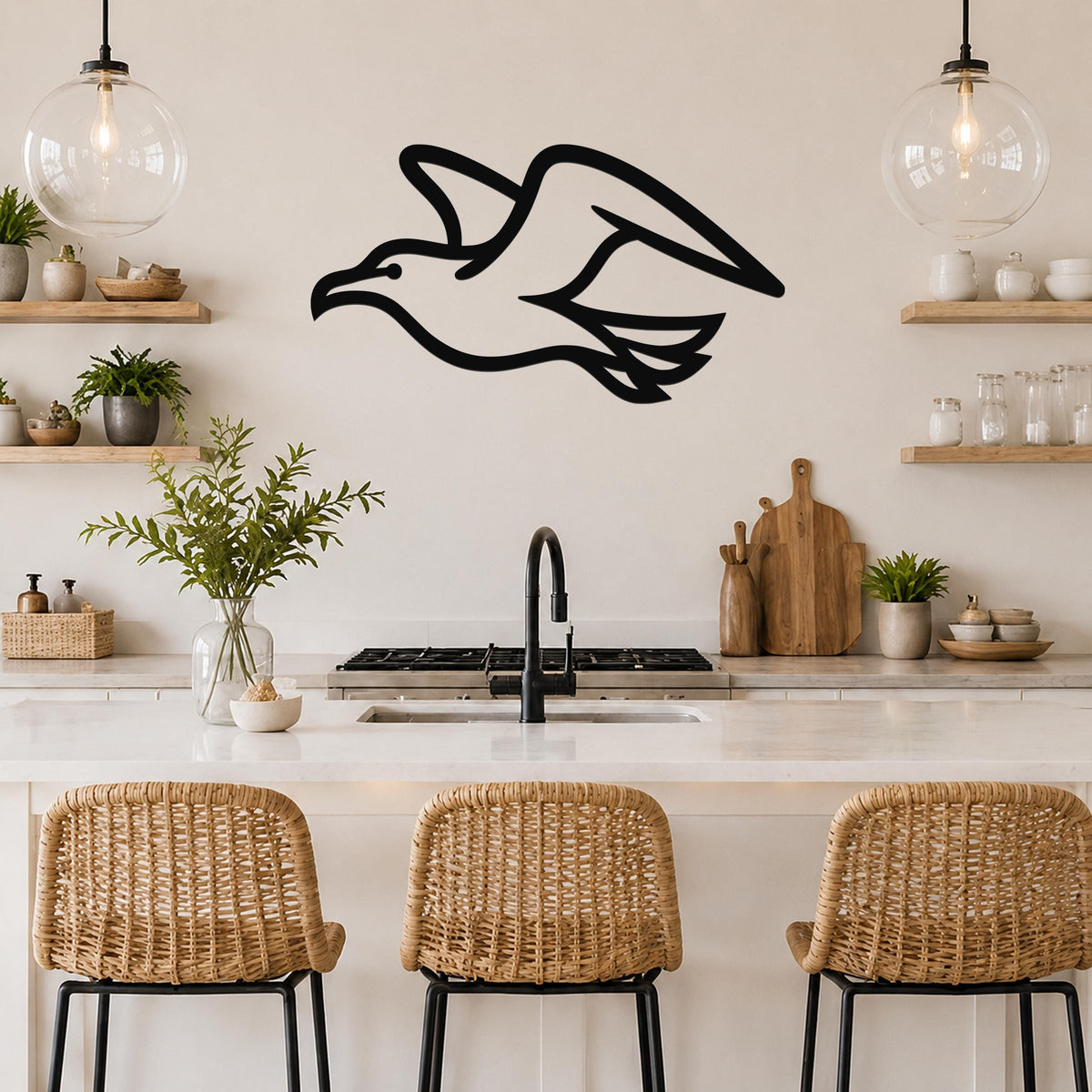 Black metal seagull wall art with a silhouette design, mounted on a kitchen wall above a counter with wicker bar stools.