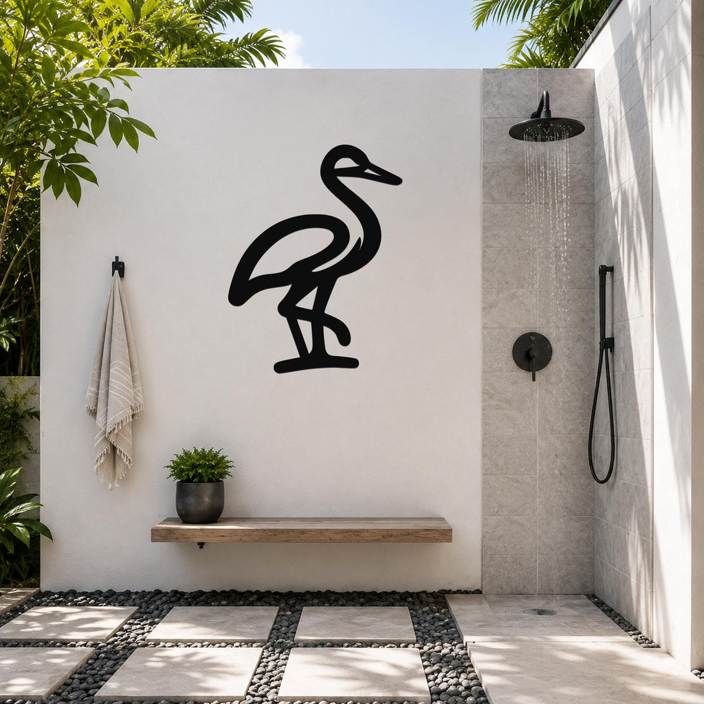 Black metal crane wall art silhouette mounted on a white outdoor wall above a wooden bench in a modern shower area.