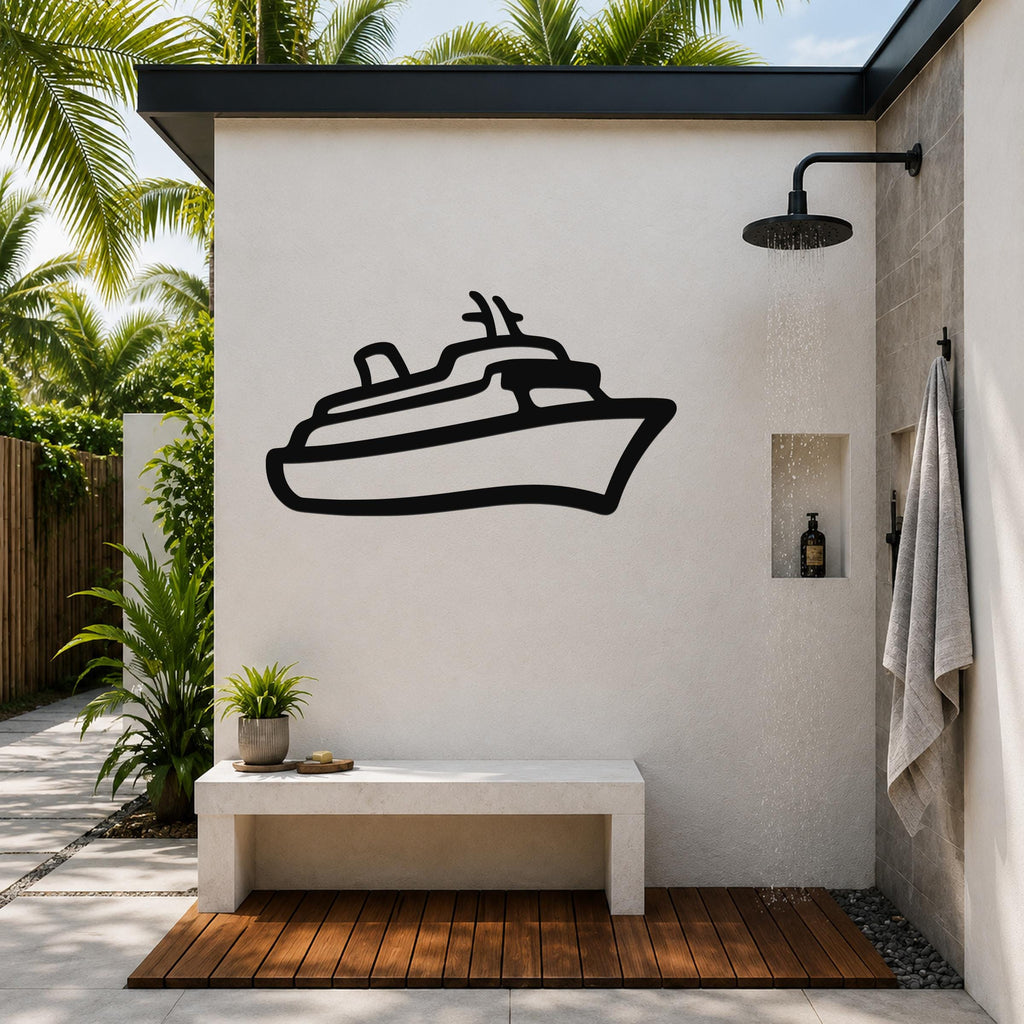 Black metal cruise ship wall art silhouette mounted on a white outdoor shower wall, above a concrete bench in a tropical patio setting.