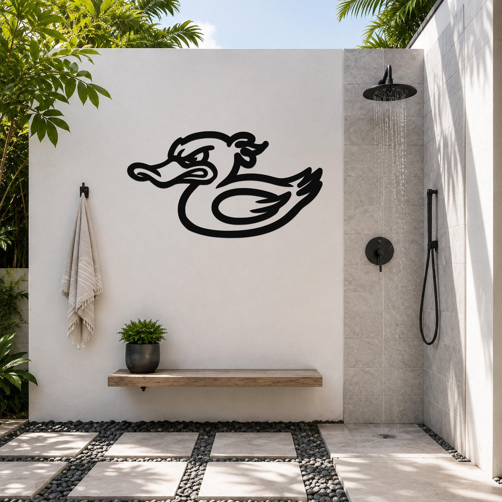 Black metal duck wall art with a bold silhouette design, mounted on a white outdoor wall above a wooden bench in a modern shower area.