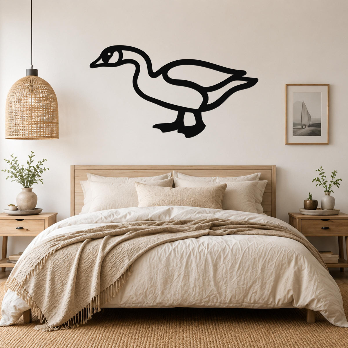 Black metal goose wall art silhouette mounted above a bed in a neutral bedroom.