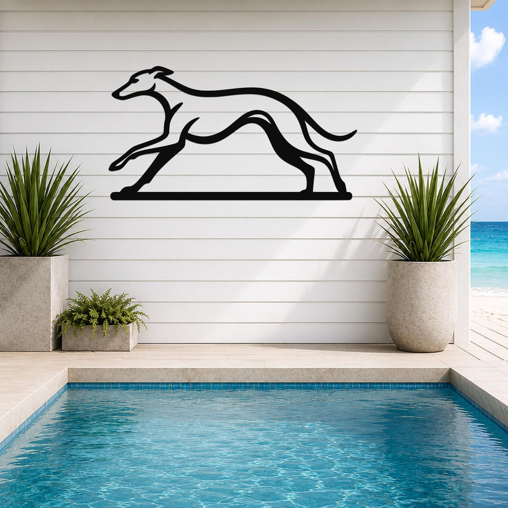 Black metal greyhound wall art with a sleek silhouette design, mounted on a white shiplap wall above a poolside patio.
