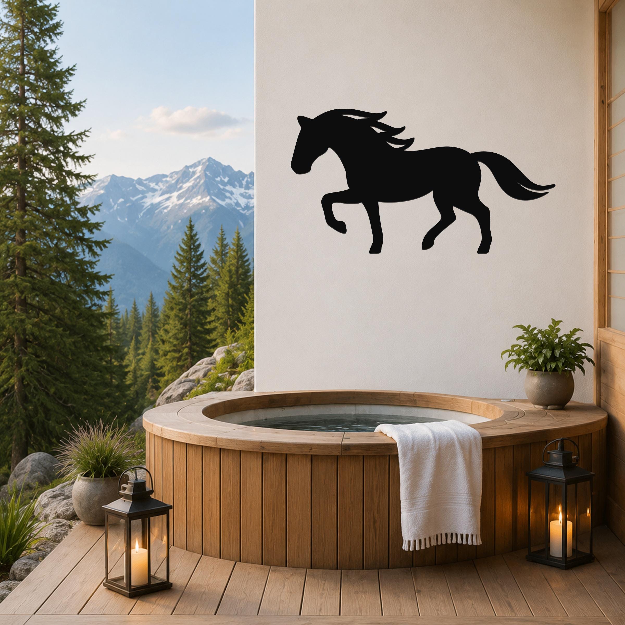 Black metal horse silhouette wall art mounted on a white wall above a wooden hot tub on a mountain-view deck.