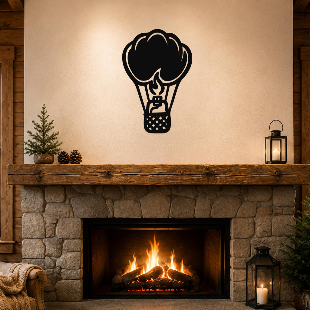 Black metal hot air balloon wall art with flame and basket cutouts, mounted above a stone fireplace in a rustic living room.