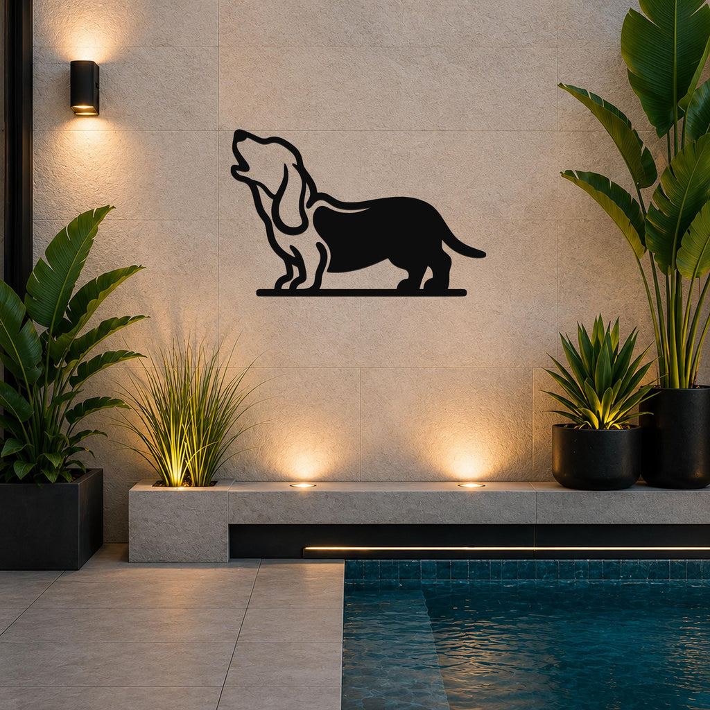 Black metal wall art of a howling basset hound silhouette, mounted on a tiled outdoor wall above a poolside planter.