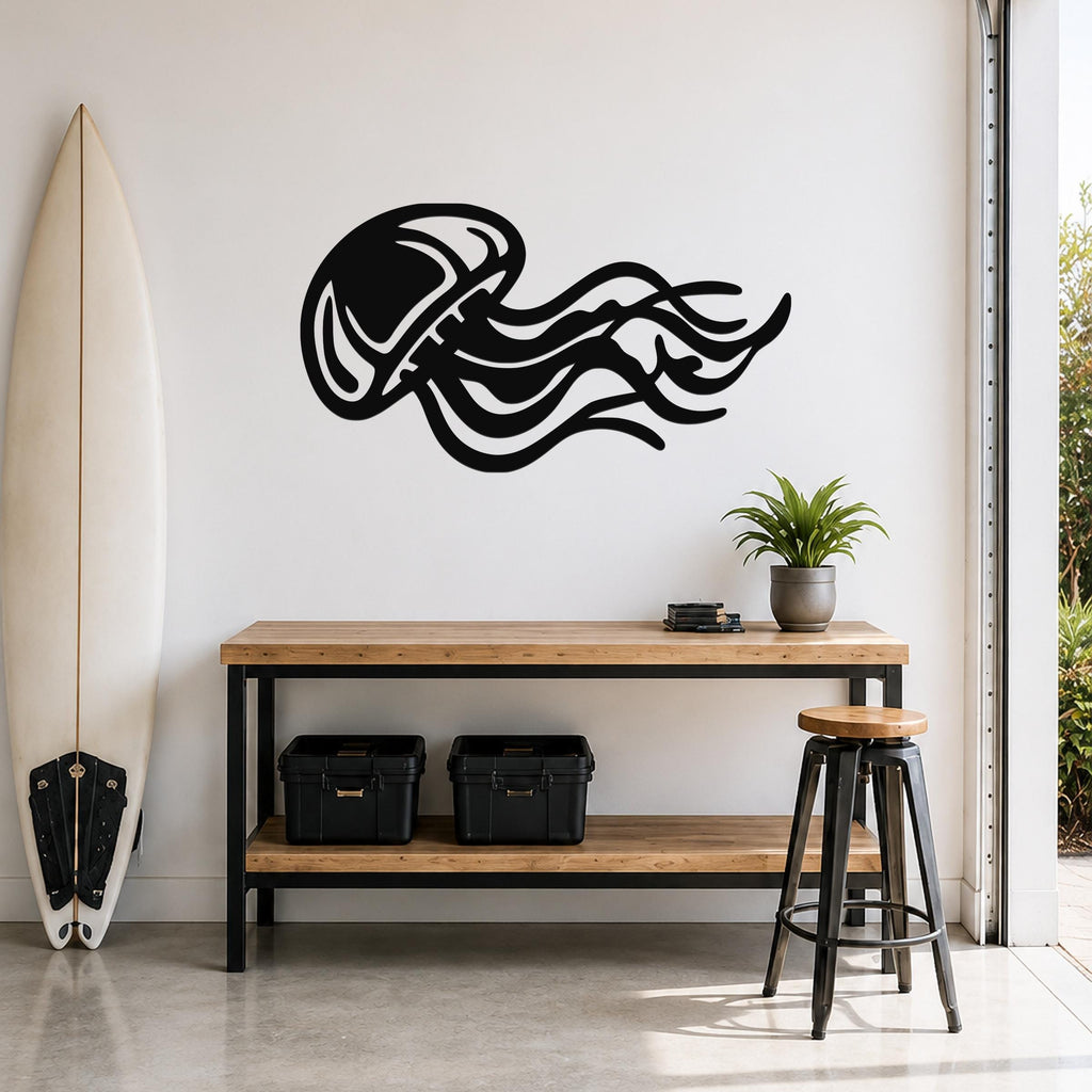 Black metal jellyfish wall art with flowing tentacle cutouts, mounted on a white wall above a wooden console table in a modern entryway.