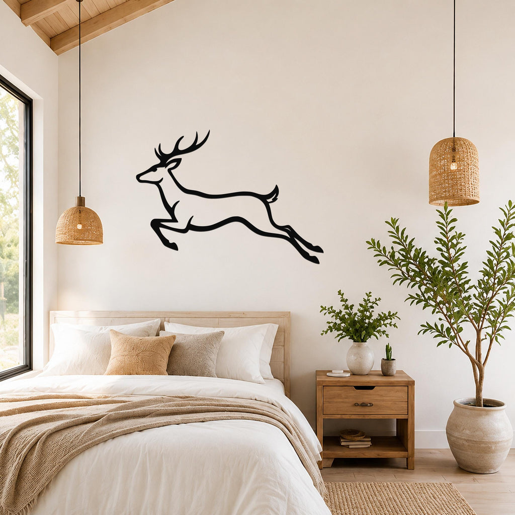 Black metal jumping deer wall art silhouette mounted above a bed in a bright bedroom with wooden furniture and woven pendant lights.