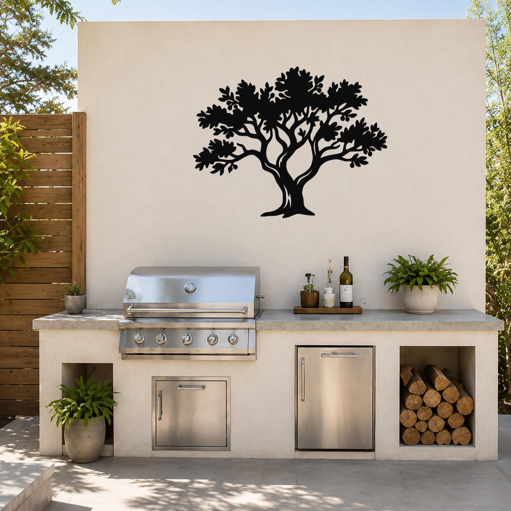 Black metal tree wall art with detailed branch and leaf cutouts, mounted on an outdoor wall above a kitchen counter.