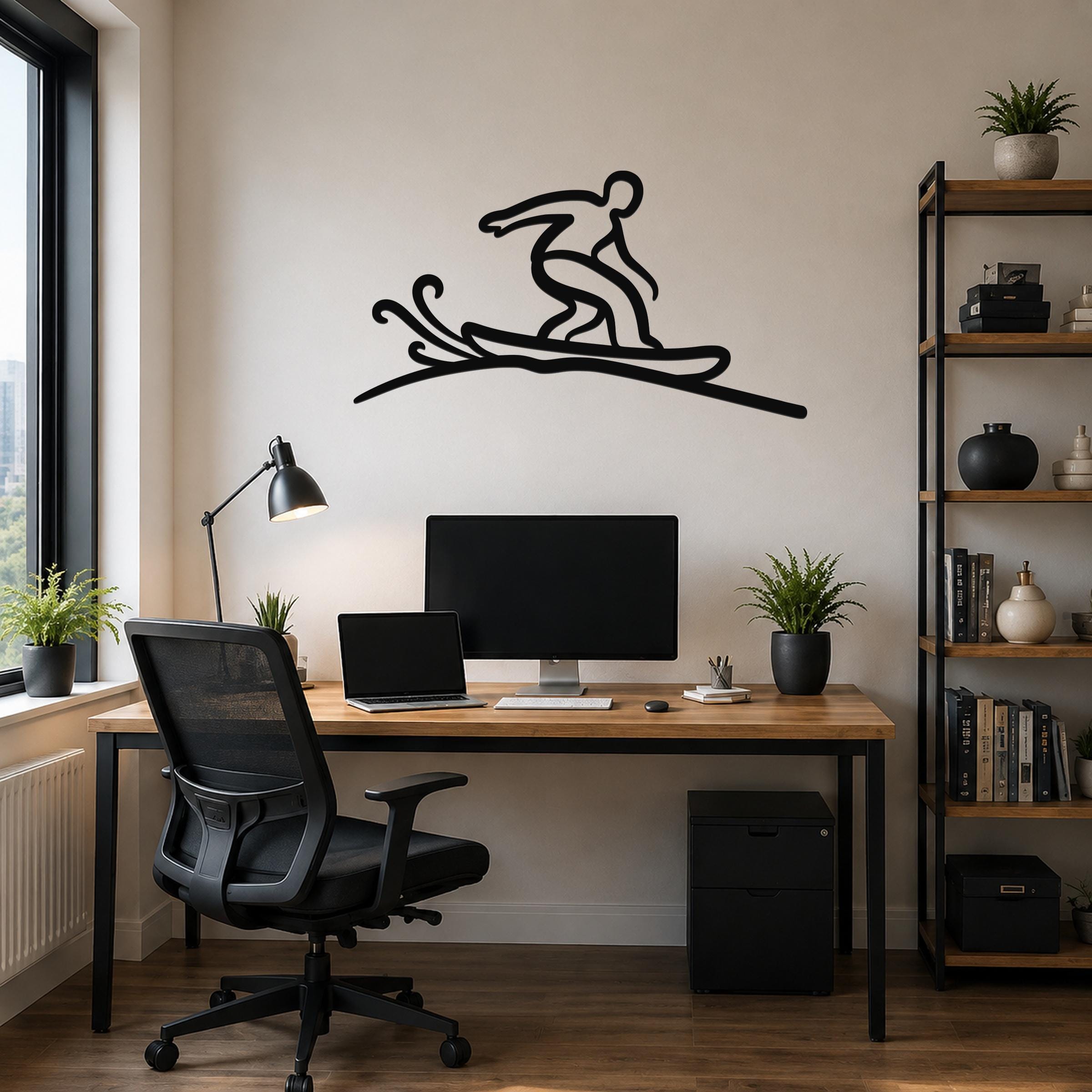 Black metal wall art silhouette of a snowboarder in motion, mounted above a wooden desk in a home office.