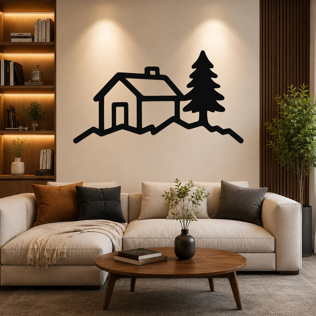 Black metal wall art silhouette of a cabin and pine tree on a hill, mounted above a sofa in a living room.