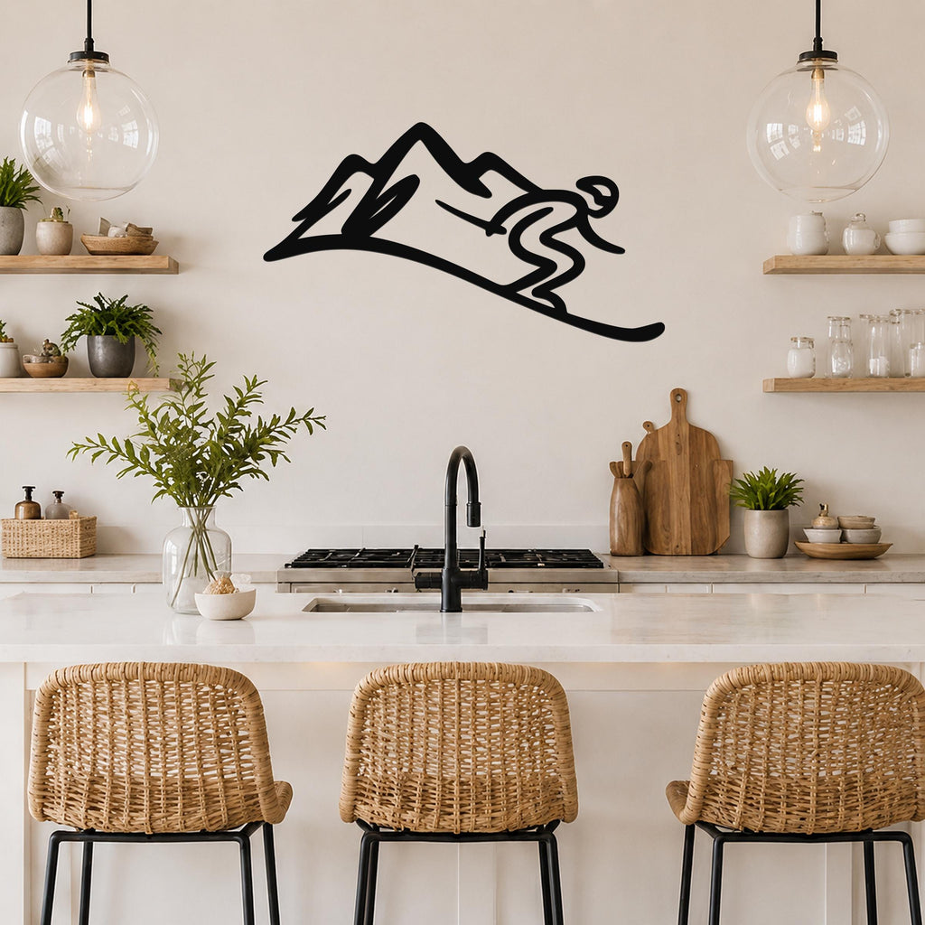 Black metal wall art featuring a skier silhouette descending a mountain, mounted above a kitchen counter with wicker bar stools.