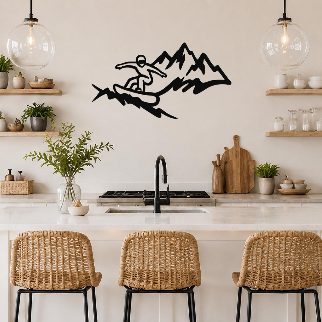 Black metal wall art featuring a snowboarder silhouette in motion against mountain peaks, mounted above a kitchen counter.