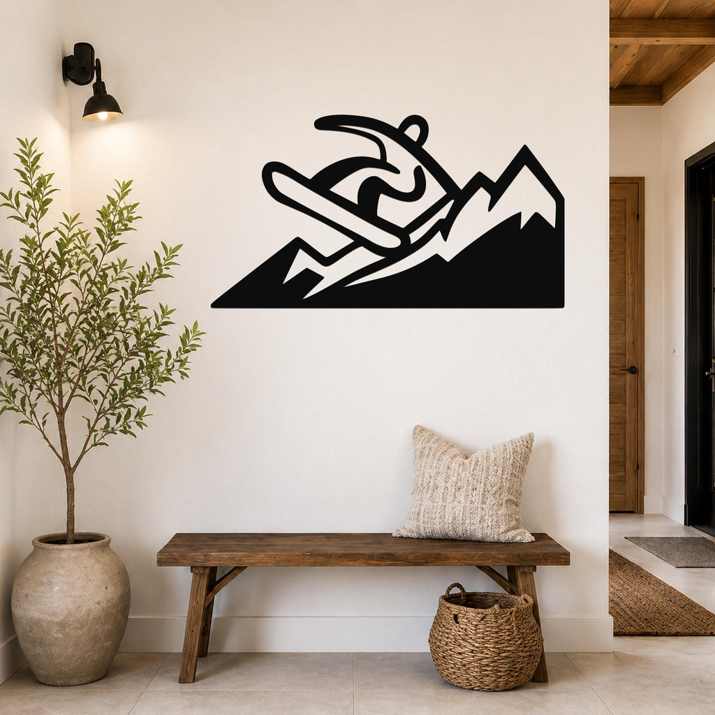 Black metal wall art featuring a snowboarder silhouette above mountain peaks, mounted on a white wall above a wooden bench in a hallway.