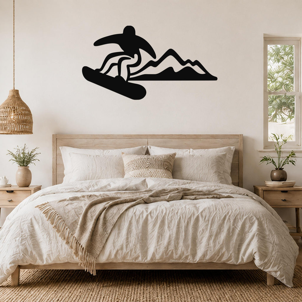 Black metal wall art featuring a snowboarder silhouette in dynamic motion above a bed, mounted on a light-colored bedroom wall.