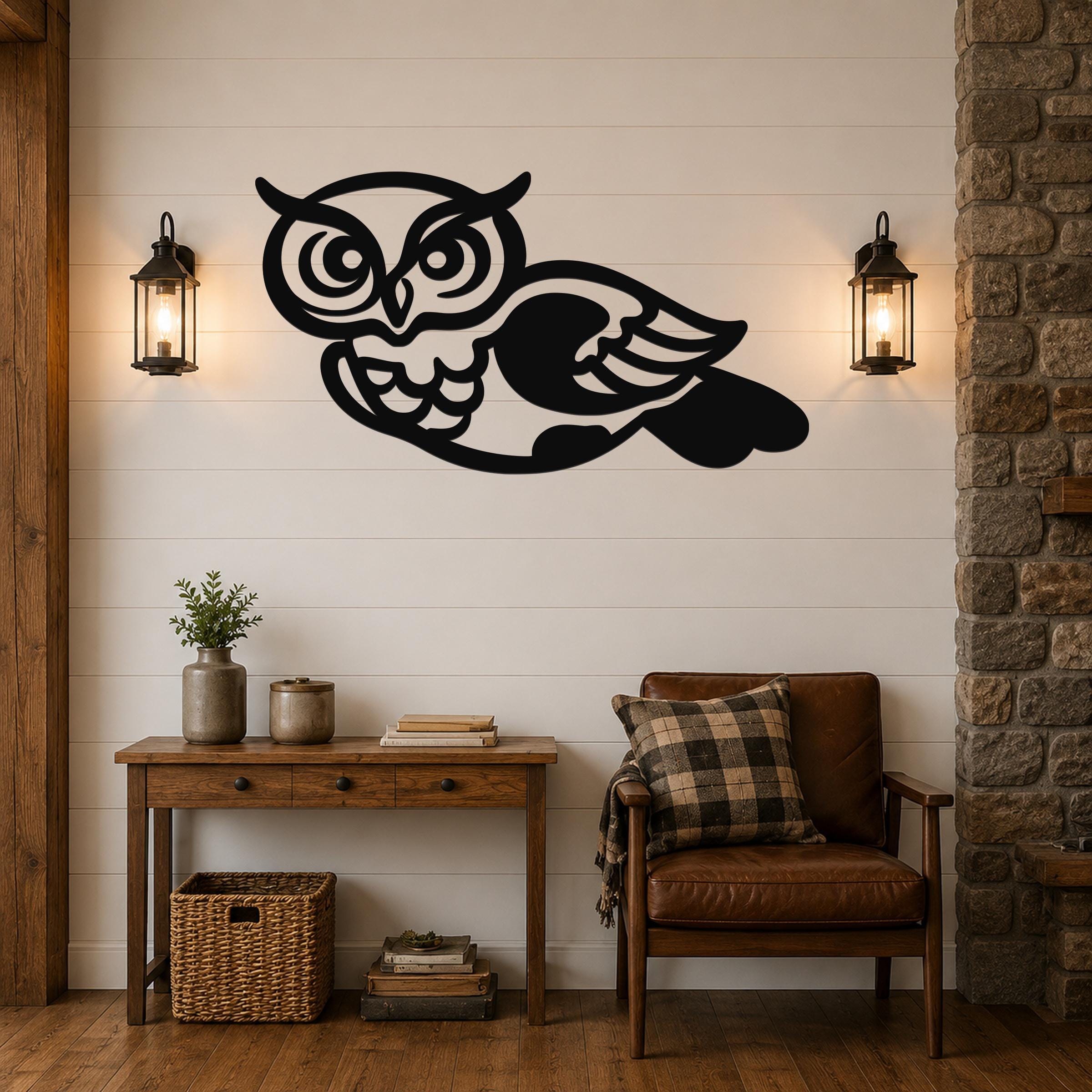Black metal owl wall art with cutout eyes and wings, mounted on a shiplap wall above a wooden console table in a living room.