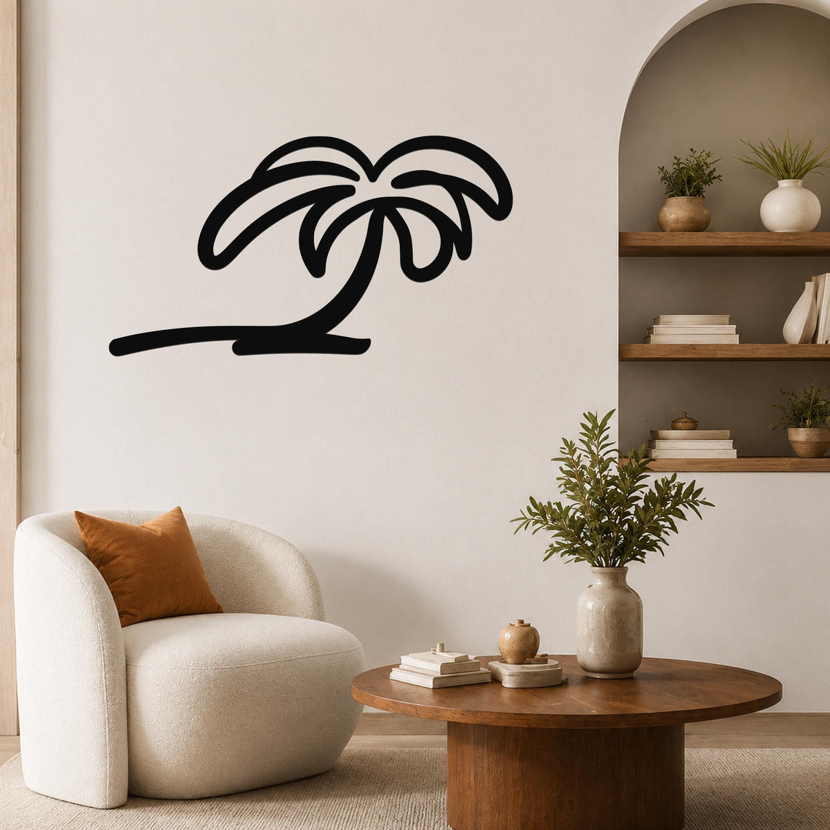 Black metal palm tree wall art with flowing frond cutouts, mounted on a living room wall above a round wooden coffee table.