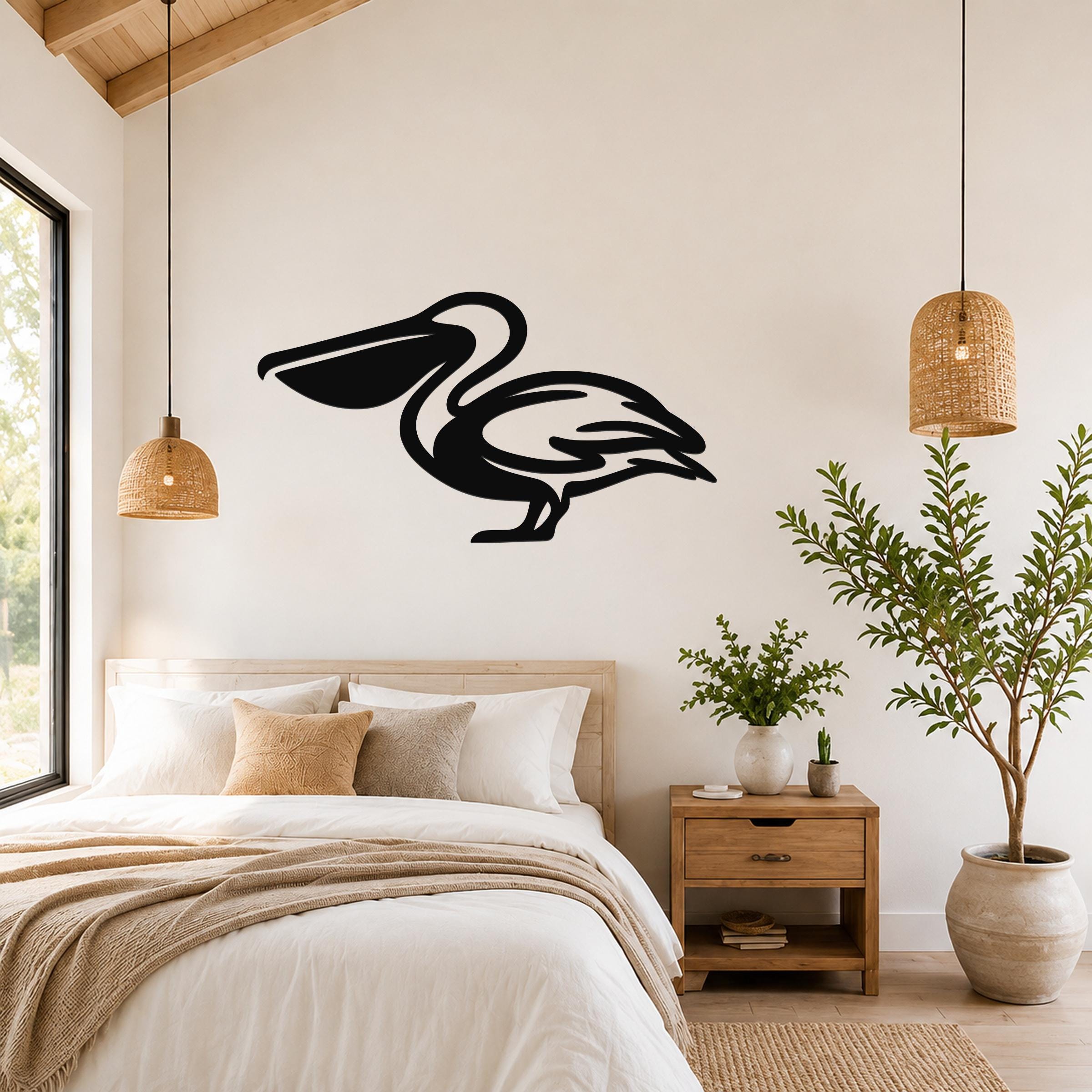 Black metal pelican wall art silhouette mounted above a bed in a bright bedroom with wooden ceiling and woven pendant lights.