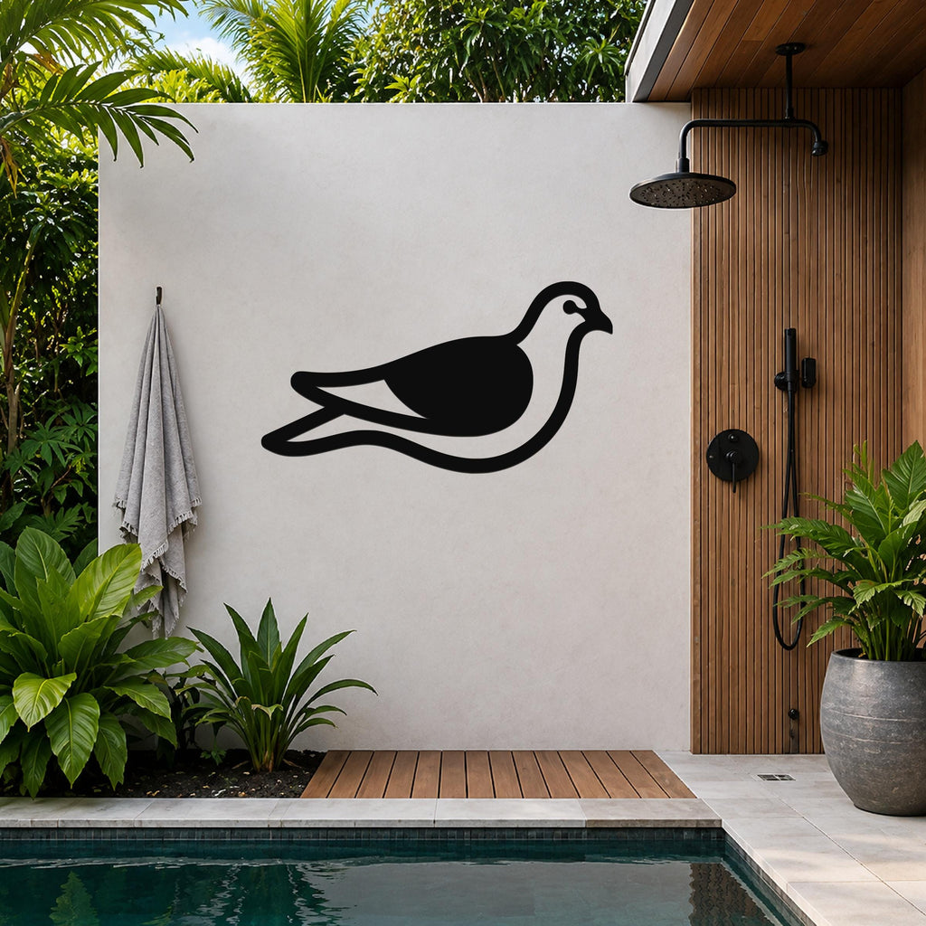 Black metal pigeon wall art with a silhouette design, mounted on a light-colored outdoor wall beside a shower and pool area.