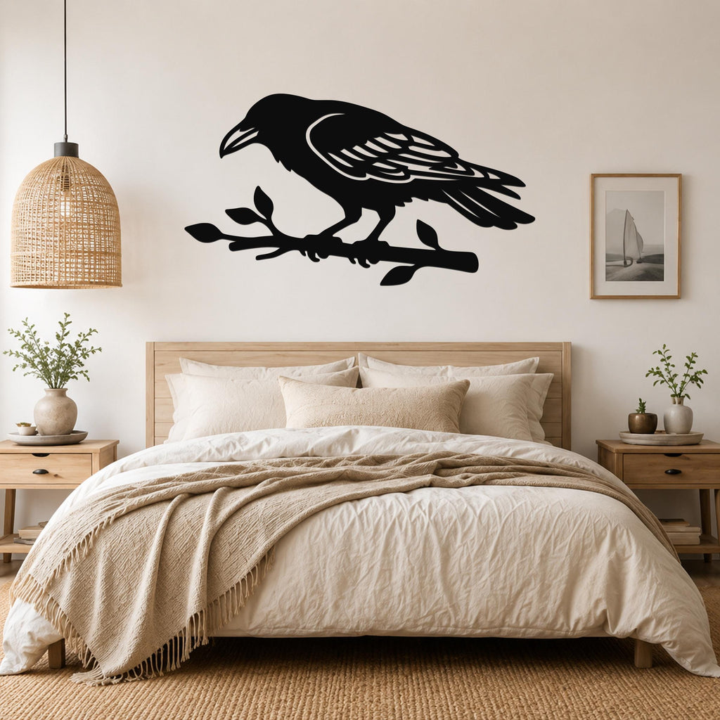 Black metal raven wall art cutout perched on a branch, mounted above a bed in a neutral bedroom.