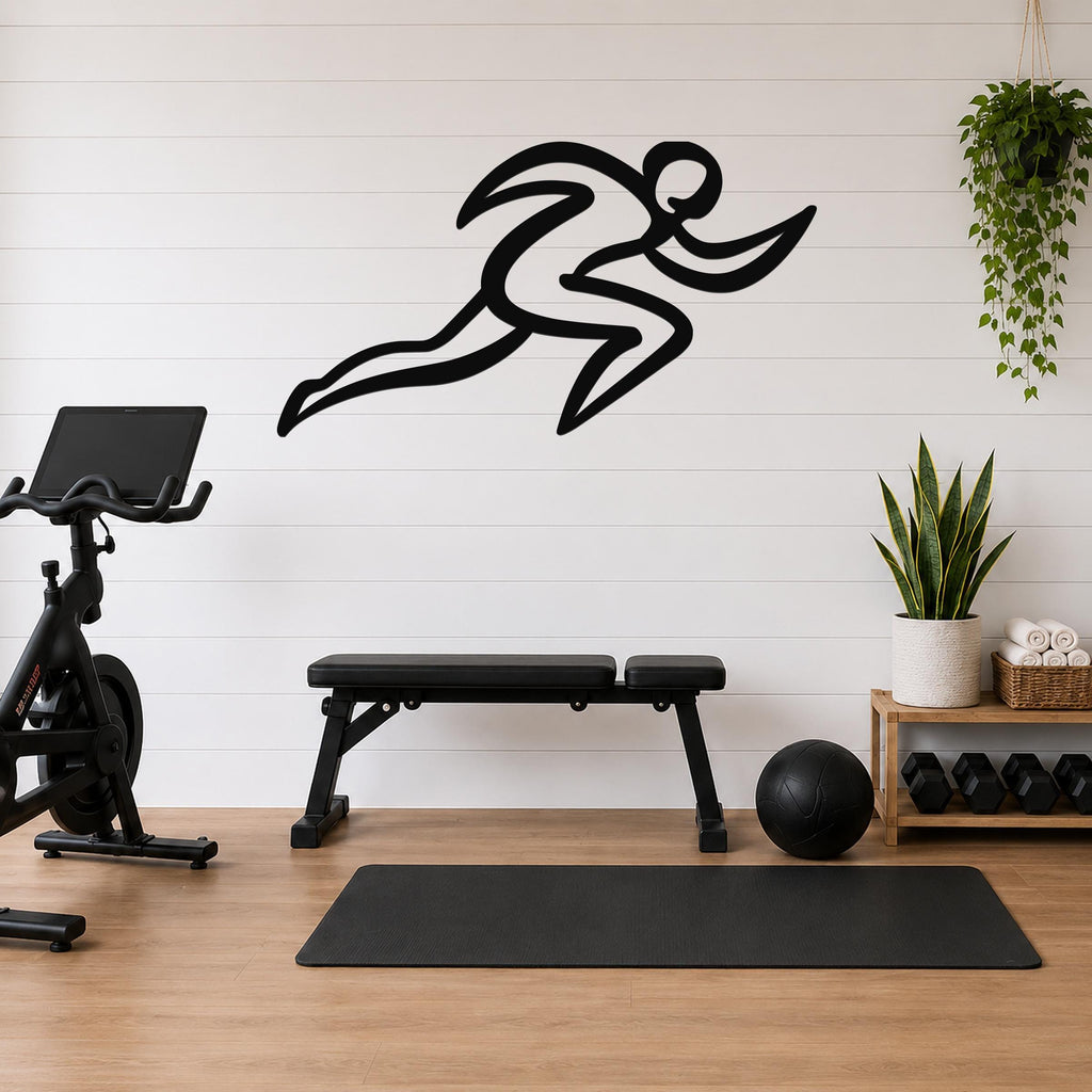 Black metal runner wall art with motion-line cutouts, mounted on a white shiplap wall above a workout bench in a home gym.