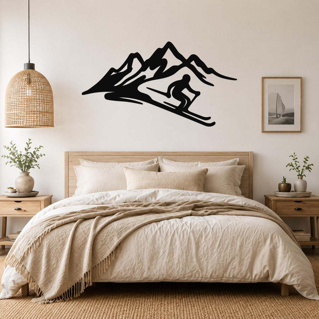 Black metal wall art of a skier in fluid motion on a mountain slope, mounted above a bed in a neutral bedroom.