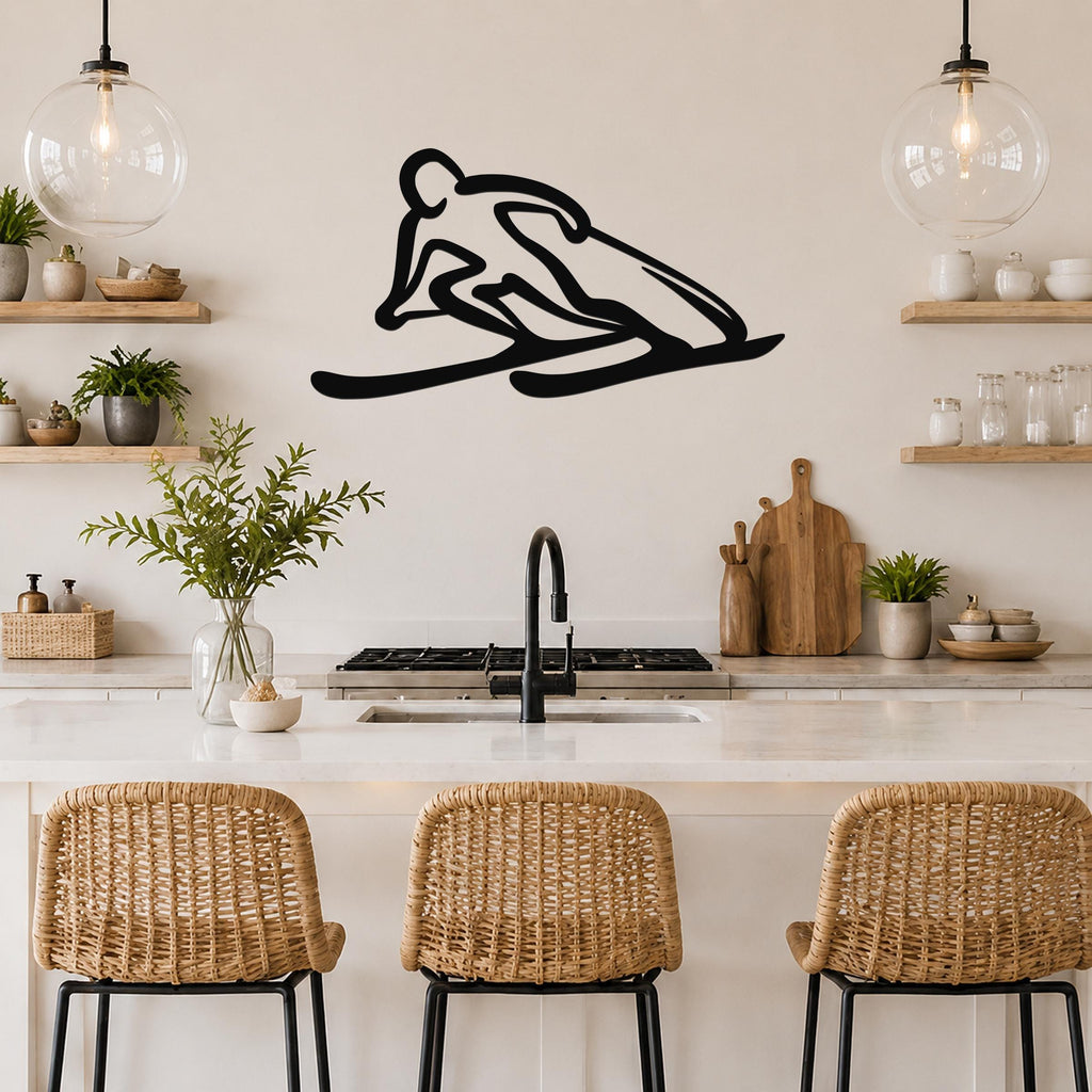 Black metal wall art of a minimalist skier silhouette, mounted above a kitchen counter with wicker bar stools and open shelving.