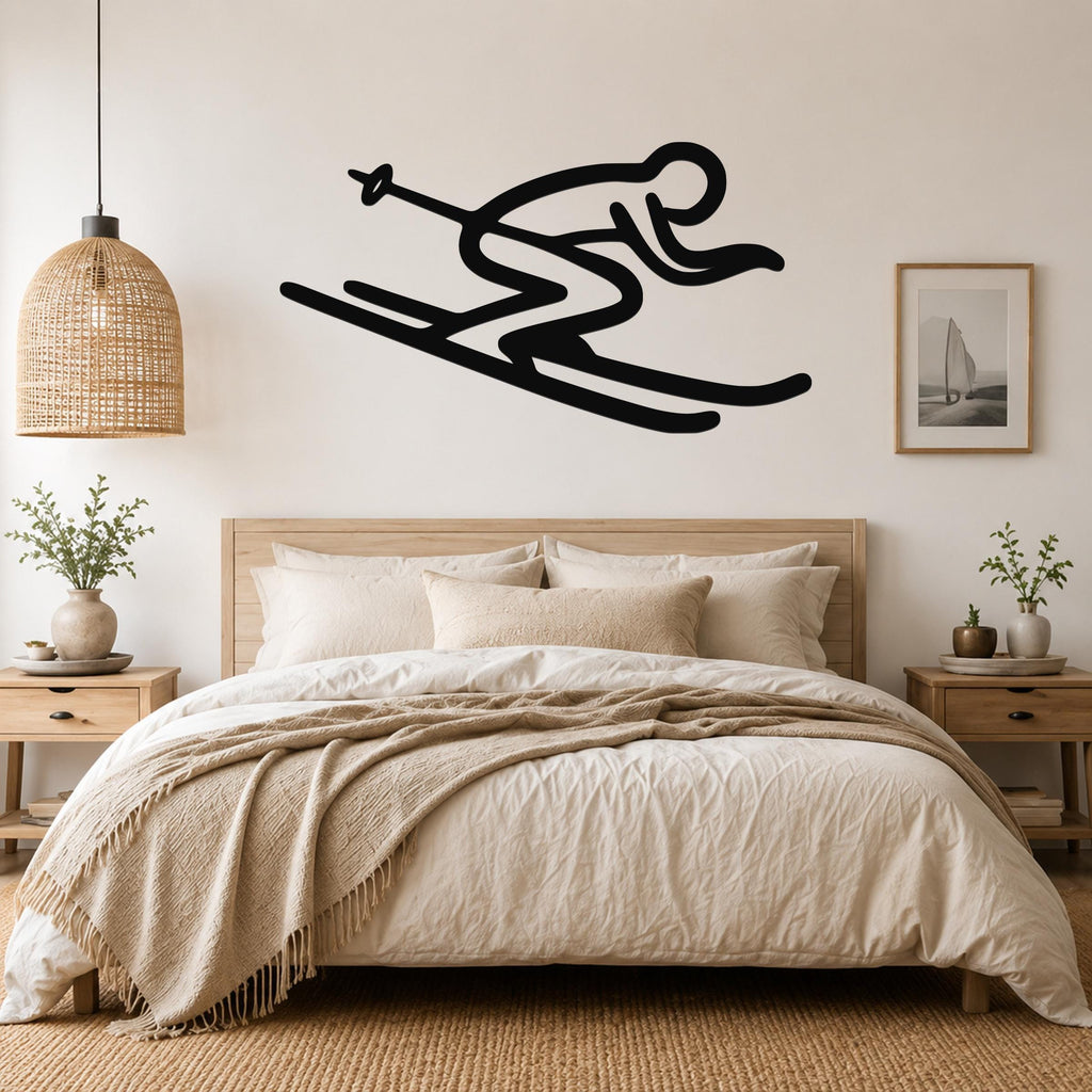 Black metal wall art silhouette of a skier in motion, mounted above a bed in a neutral bedroom.