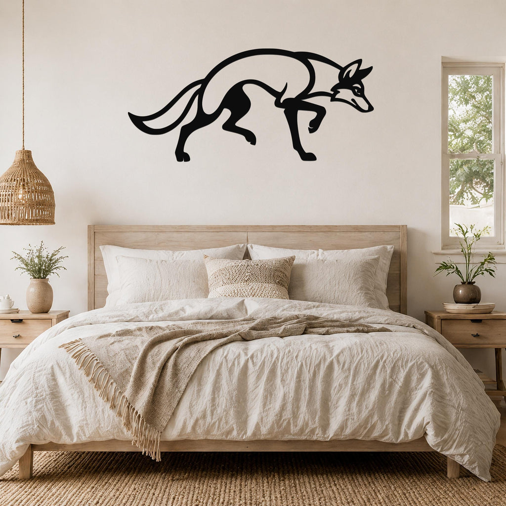 Black metal coyote wall art silhouette with motion-line cutouts, mounted above a wooden bed in a neutral bedroom.