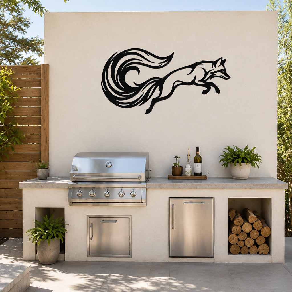 Black metal fox wall art with flowing tail cutout, mounted on an outdoor kitchen wall above a stainless steel grill.