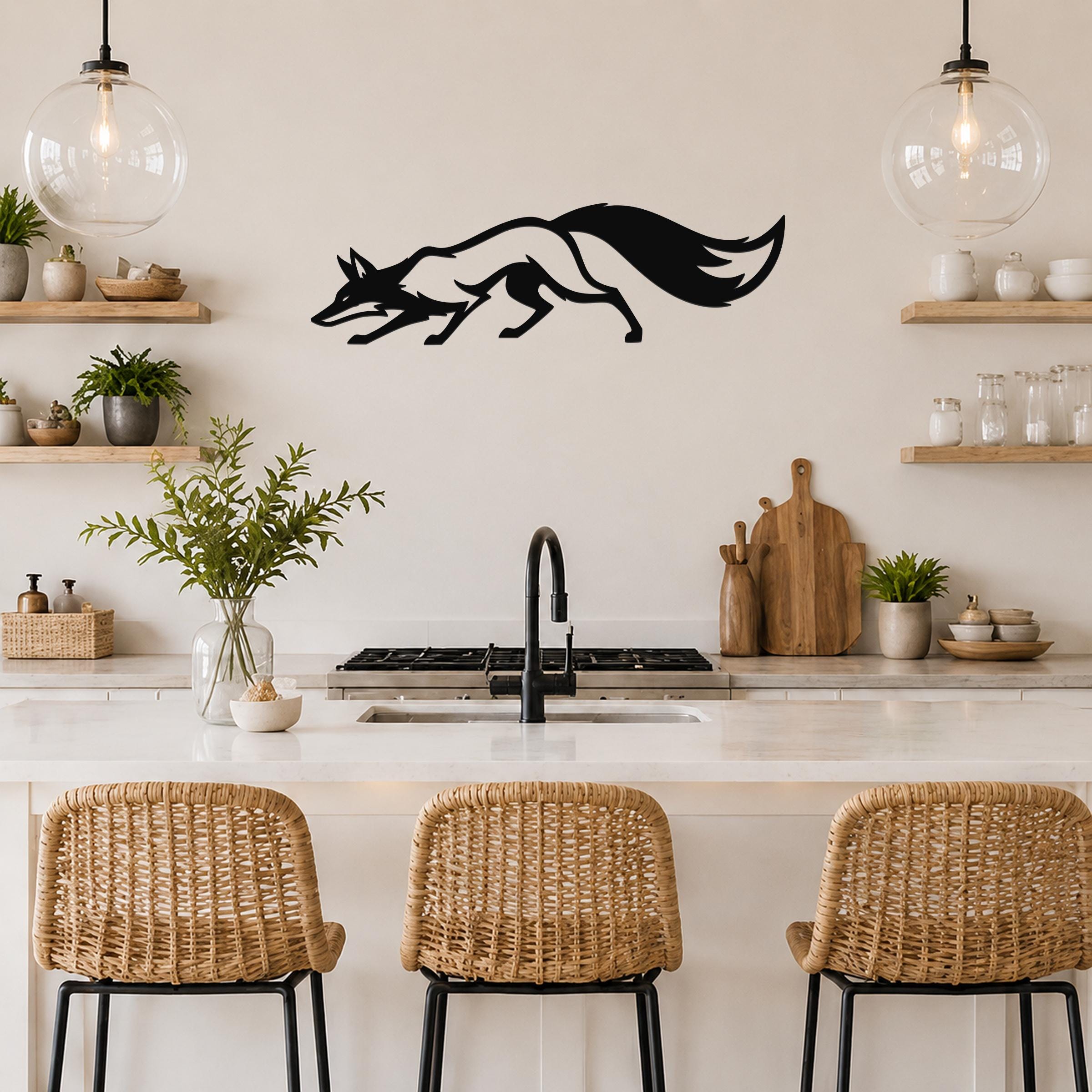 Black metal fox wall art silhouette with motion lines, mounted above a kitchen counter in a modern kitchen.