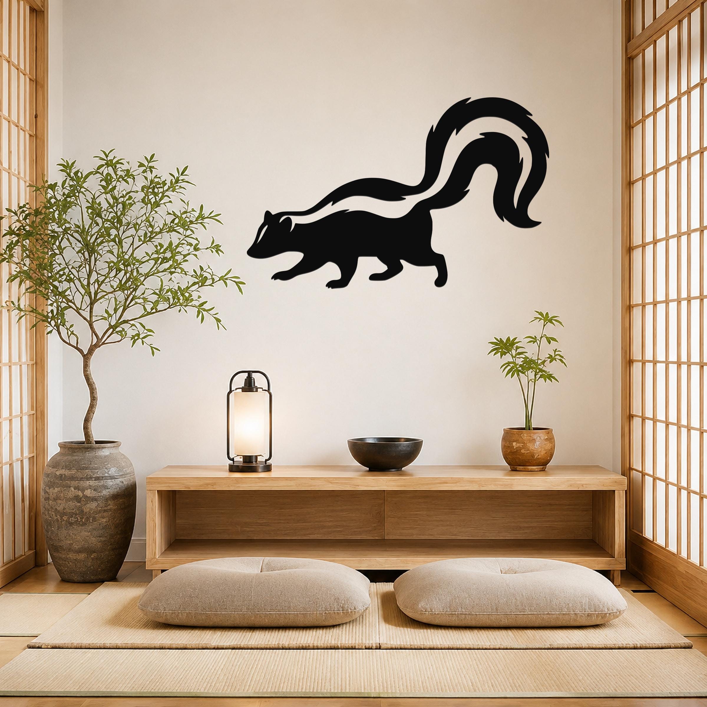 Black metal skunk wall art silhouette with a curved tail, mounted on a light-colored wall above a wooden console in a minimalist room.