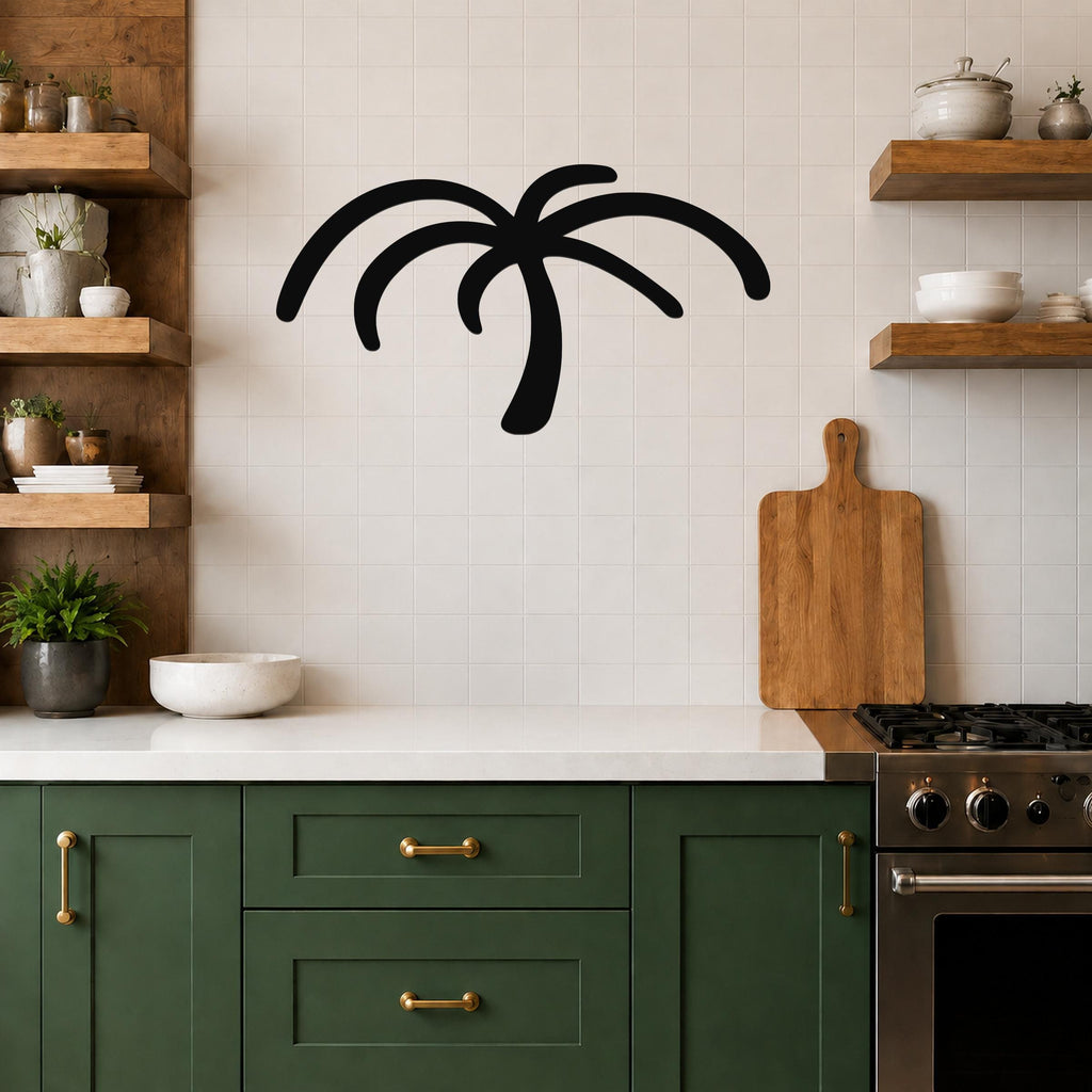 Black metal palm tree wall art with curved frond cutouts, mounted on a tiled kitchen wall above a counter.