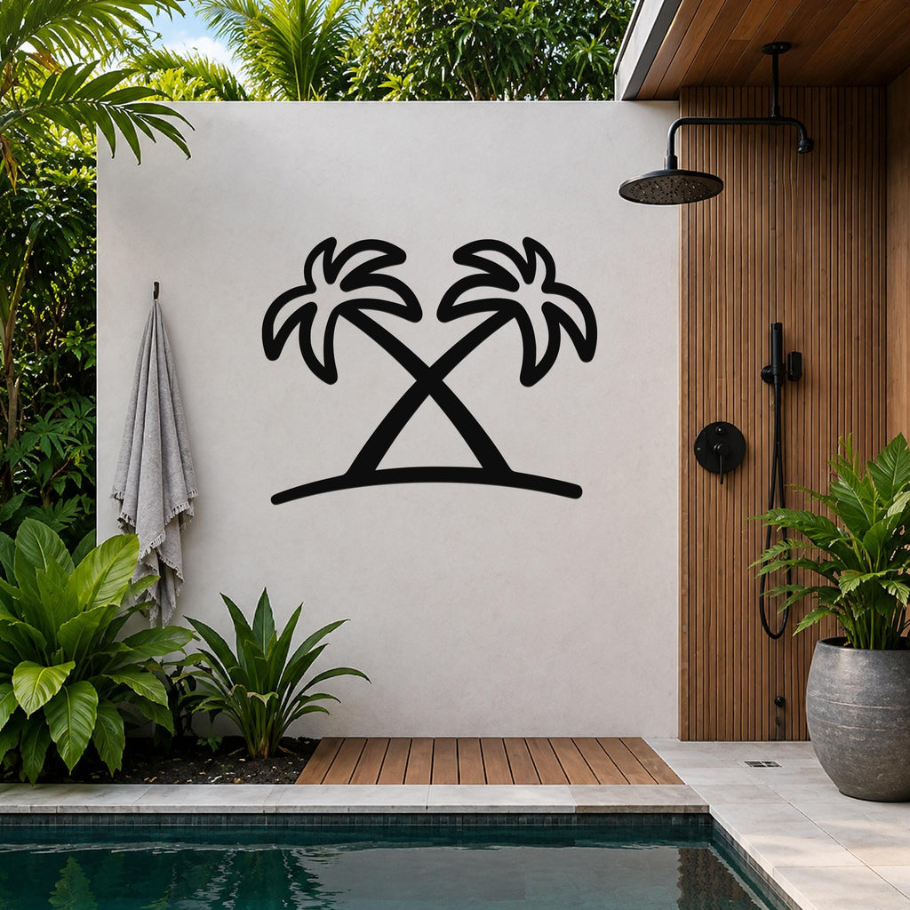 Black metal palm tree wall art with two crossed silhouettes, mounted on a white outdoor wall beside a wooden shower enclosure and pool.