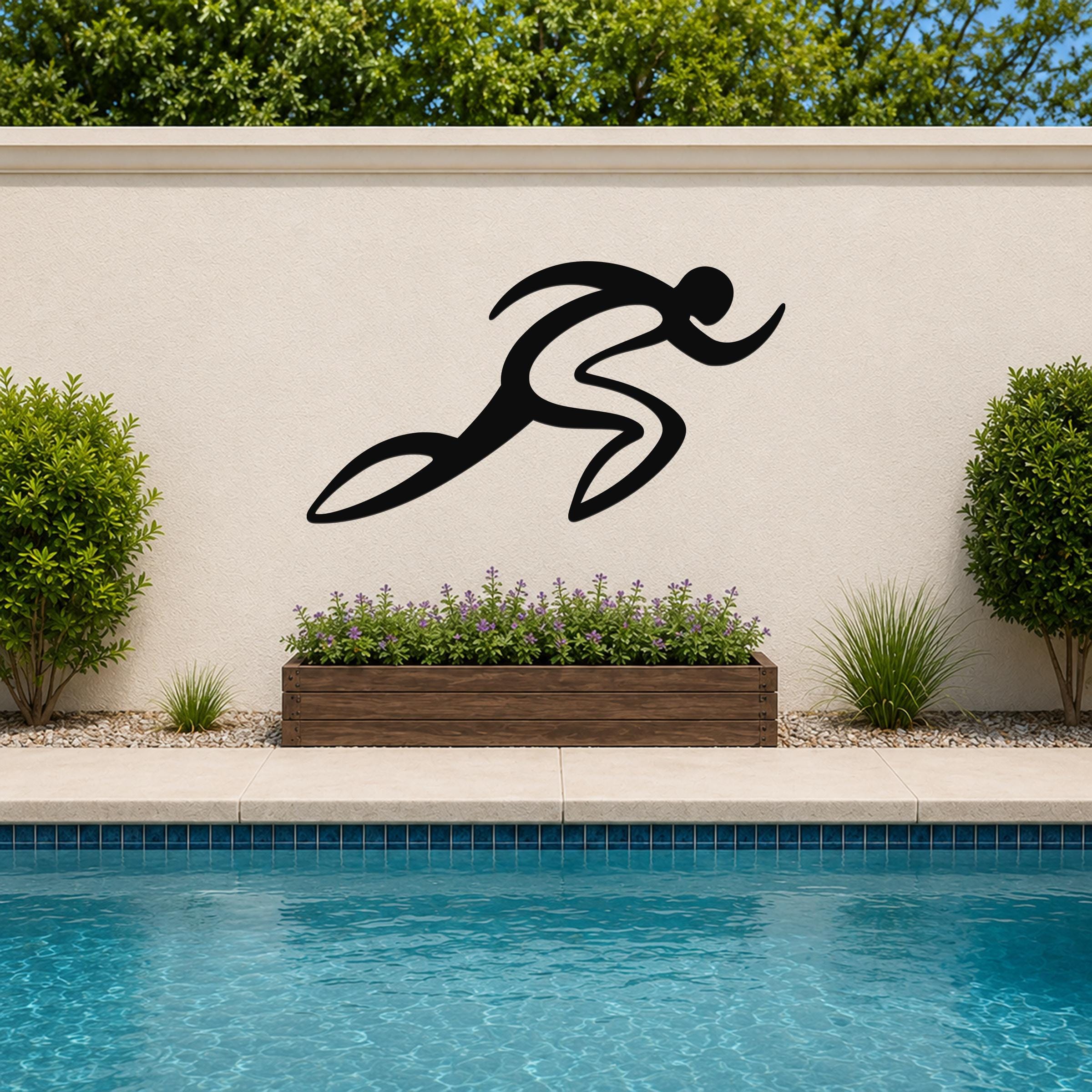 Black metal runner wall art with flowing motion lines, mounted on an outdoor wall above a poolside planter.
